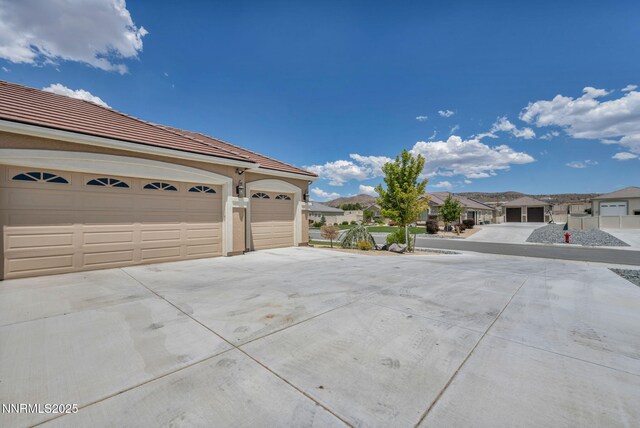 11575 Anthem Dr, Spanish Springs, NV 89441 - view of home's exterior featuring driveway, a residential view, and a tile roof