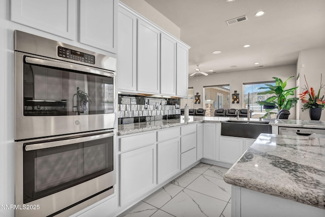 11575 Anthem Dr, Spanish Springs, NV 89441 - kitchen featuring appliances with stainless steel finishes, recessed lighting, light marble finish floors, white cabinets, and ceiling fan
