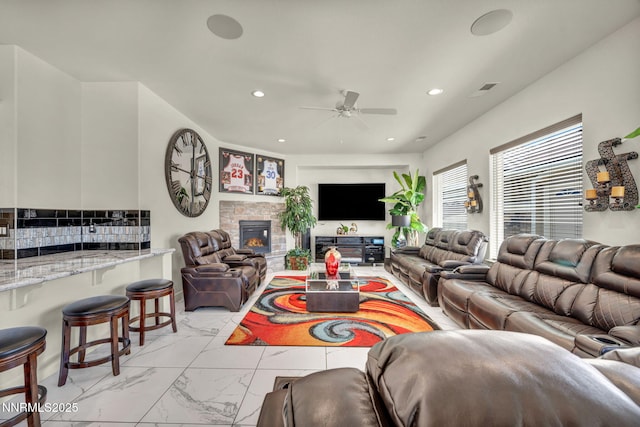 11575 Anthem Dr, Spanish Springs, NV 89441 - living area featuring light marble finish flooring, a ceiling fan, recessed lighting, and a stone fireplace