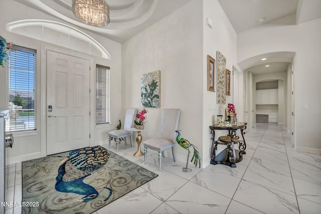 11575 Anthem Dr, Spanish Springs, NV 89441 - foyer featuring arched walkways, light marble finish floors, a chandelier, and recessed lighting