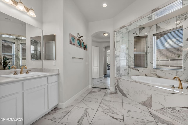 11575 Anthem Dr, Spanish Springs, NV 89441 - bathroom with marble look tiles, a garden tub, vanity, a marble finish shower, and recessed lighting