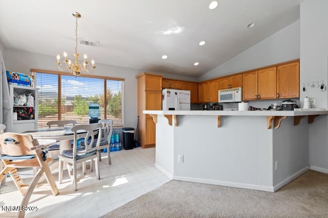 900 Ponderosa Ct, Dayton, NV 89403 - kitchen featuring white appliances, tile counters, a chandelier, a breakfast bar area, and a peninsula