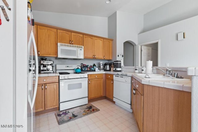 900 Ponderosa Ct, Dayton, NV 89403 - kitchen featuring white appliances, light flooring, tile countertops, and a peninsula