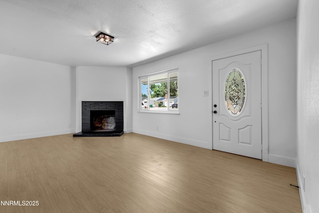 1125 Vance Way, Sparks, NV 89431 - entrance foyer featuring light wood-style floors, a fireplace, and a textured ceiling