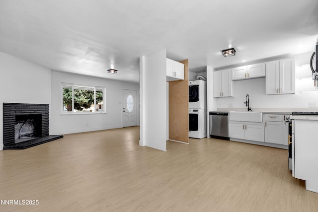 1125 Vance Way, Sparks, NV 89431 - kitchen with stainless steel appliances, estacked washer and dryer, open floor plan, light wood-type flooring, and light countertops
