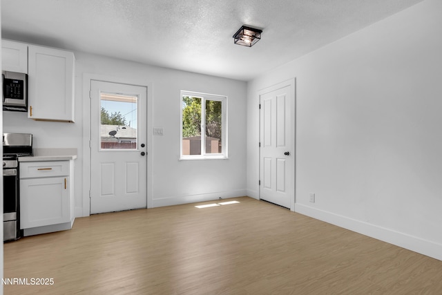 1125 Vance Way, Sparks, NV 89431 - kitchen with stainless steel appliances, light wood finished floors, white cabinets, light countertops, and a textured ceiling