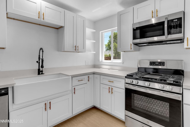 1125 Vance Way, Sparks, NV 89431 - kitchen with appliances with stainless steel finishes, light countertops, open shelves, and white cabinetry