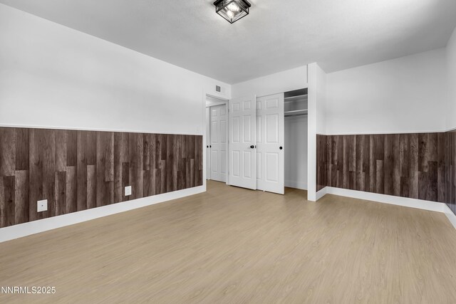 1125 Vance Way, Sparks, NV 89431 - unfurnished bedroom with wood finished floors, a closet, and a wainscoted wall