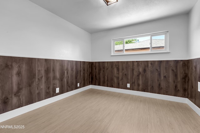 1125 Vance Way, Sparks, NV 89431 - unfurnished room featuring wood finished floors, a wainscoted wall, and wooden walls