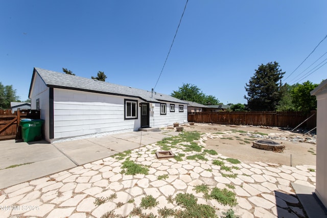 1125 Vance Way, Sparks, NV 89431 - back of property with an outdoor fire pit, a patio, and roof with shingles