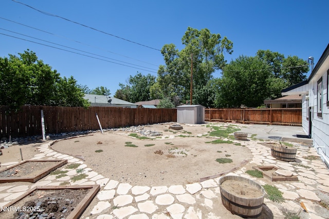 1125 Vance Way, Sparks, NV 89431 - fenced backyard featuring a patio area, a storage unit, and an outdoor fire pit