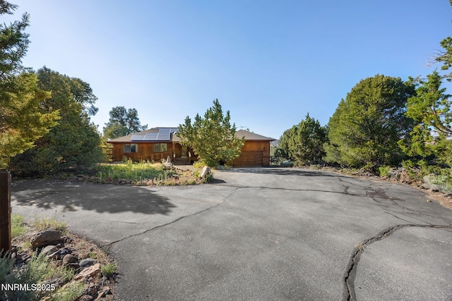 2260 Empire Rd, Reno, NV 89521 - view of front of house with asphalt driveway and roof mounted solar panels