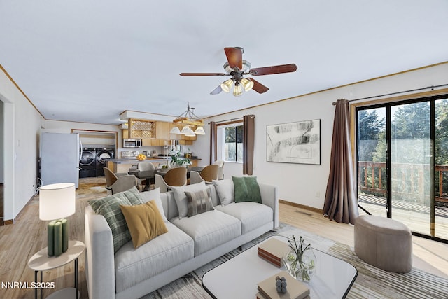 2260 Empire Rd, Reno, NV 89521 - living area featuring a ceiling fan, light wood-style floors, and independent washer and dryer