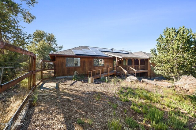 2260 Empire Rd, Reno, NV 89521 - back of property with roof mounted solar panels and a sunroom