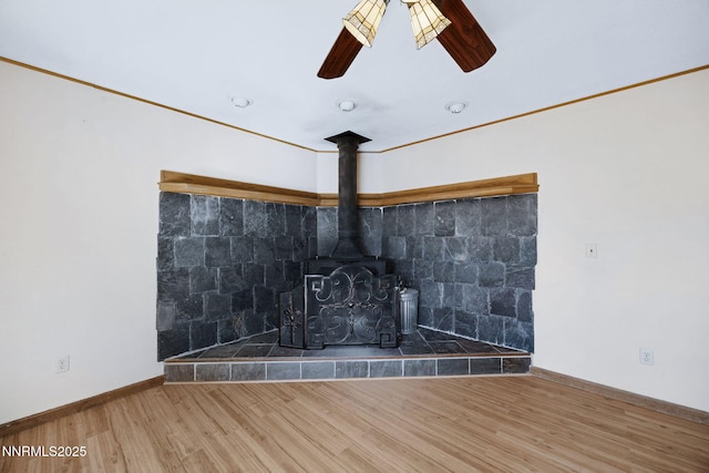 2260 Empire Rd, Reno, NV 89521 - detailed view of wood finished floors, a ceiling fan, and a wood stove