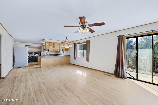 2260 Empire Rd, Reno, NV 89521 - unfurnished living room with washer and clothes dryer, light wood-style flooring, and a ceiling fan