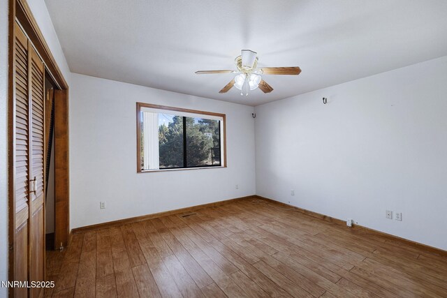 2260 Empire Rd, Reno, NV 89521 - unfurnished bedroom featuring wood finished floors, a closet, and a ceiling fan