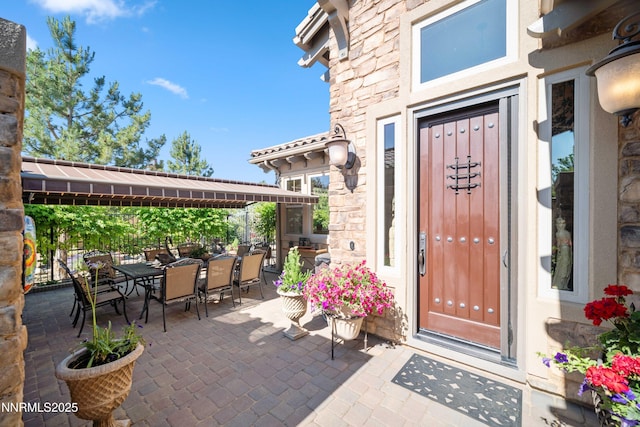 3970 Nature Trl, Reno, NV 89511 - view of exterior entry with stone siding and outdoor dining space