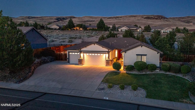 4525 Cobra Dr, Sparks, NV 89436 - ranch-style home featuring a garage, a mountain view, concrete driveway, and stucco siding