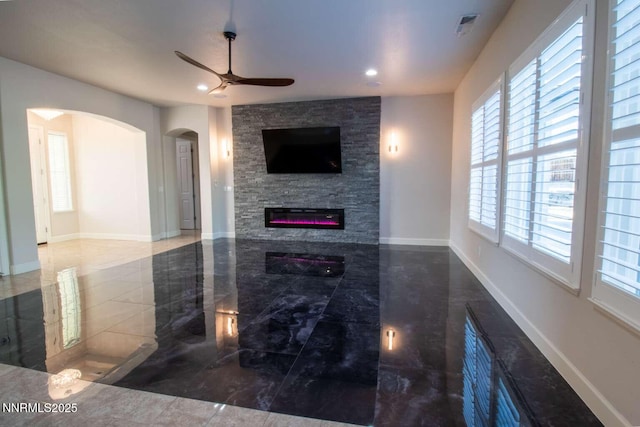 4525 Cobra Dr, Sparks, NV 89436 - living area featuring ceiling fan, arched walkways, marble finish flooring, a fireplace, and recessed lighting