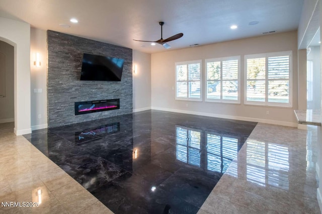 4525 Cobra Dr, Sparks, NV 89436 - unfurnished living room featuring ceiling fan, healthy amount of natural light, a fireplace, arched walkways, and recessed lighting