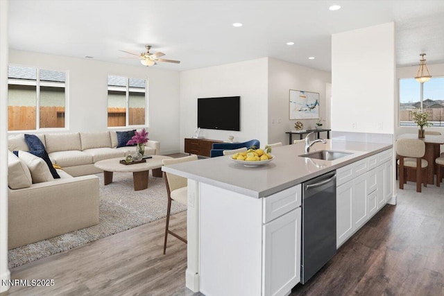 847 Agate Way, Fernley, NV 89408 - kitchen with stainless steel dishwasher, dark wood-type flooring, white cabinets, open floor plan, and recessed lighting