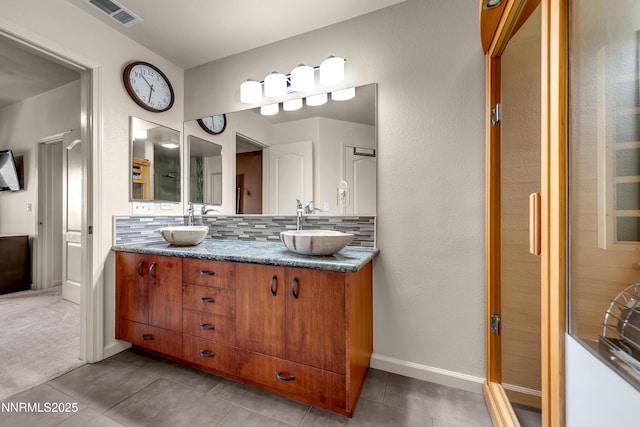 17000 Wedge Pkwy Unit 1221, Reno, NV 89511 - bathroom with backsplash, double vanity, and tile patterned floors