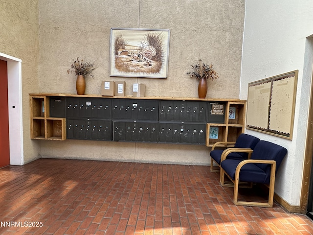 3095 Lakeside Dr # 103, Reno, NV 89509 - sitting room with mail area, brick floors, and a textured wall