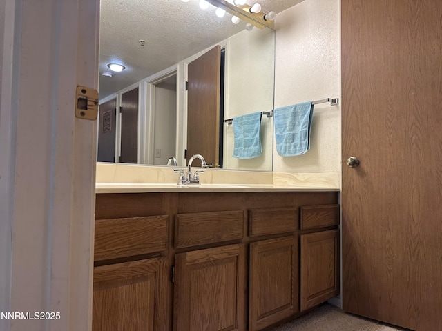3095 Lakeside Dr # 103, Reno, NV 89509 - bathroom featuring vanity and a textured ceiling