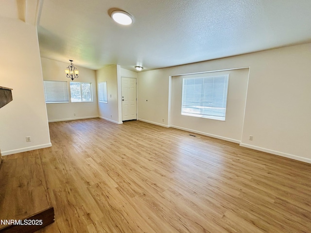 4040 Placer Way, Winnemucca, NV 89445 - unfurnished living room featuring a chandelier and light wood-type flooring
