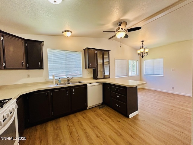 4040 Placer Way, Winnemucca, NV 89445 - kitchen featuring white appliances, a peninsula, vaulted ceiling, light wood finished floors, and light countertops