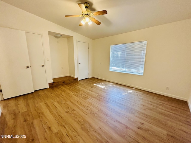 4040 Placer Way, Winnemucca, NV 89445 - unfurnished bedroom with vaulted ceiling, light wood-type flooring, and a ceiling fan