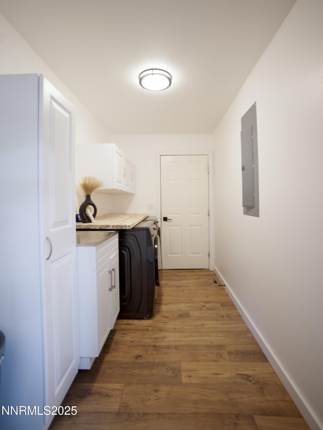 5875 Brooke Dr, Winnemucca, NV 89445 - laundry room with cabinet space, electric panel, and wood finished floors