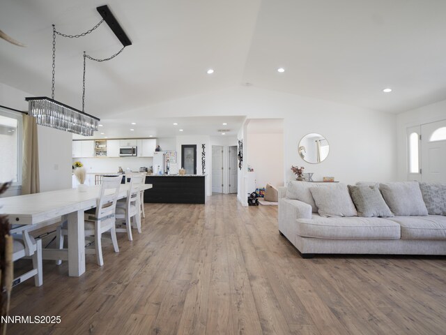 5875 Brooke Dr, Winnemucca, NV 89445 - living room featuring vaulted ceiling, recessed lighting, and wood finished floors