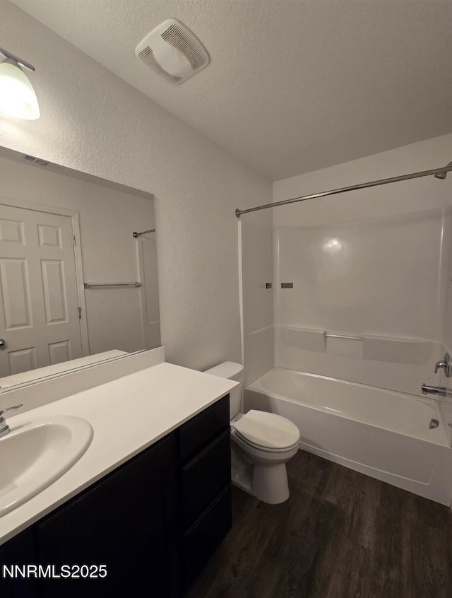 9615 Nautical Mile Rd, Reno, NV 89506 - bathroom featuring wood finished floors, shower / washtub combination, vanity, a textured wall, and a textured ceiling