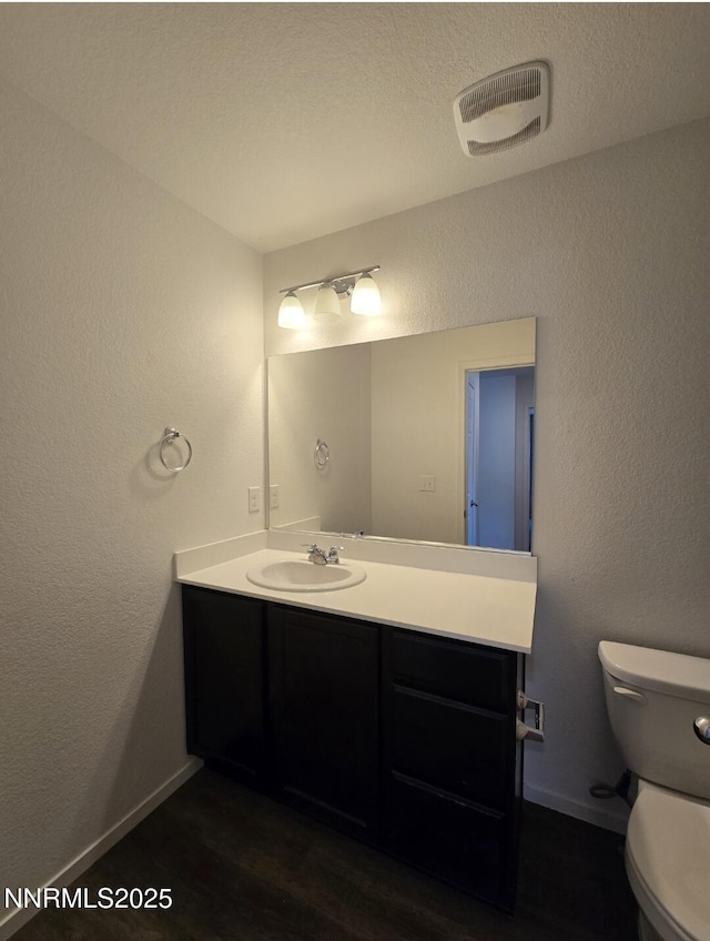 9615 Nautical Mile Rd, Reno, NV 89506 - bathroom with vanity, a textured wall, and wood finished floors