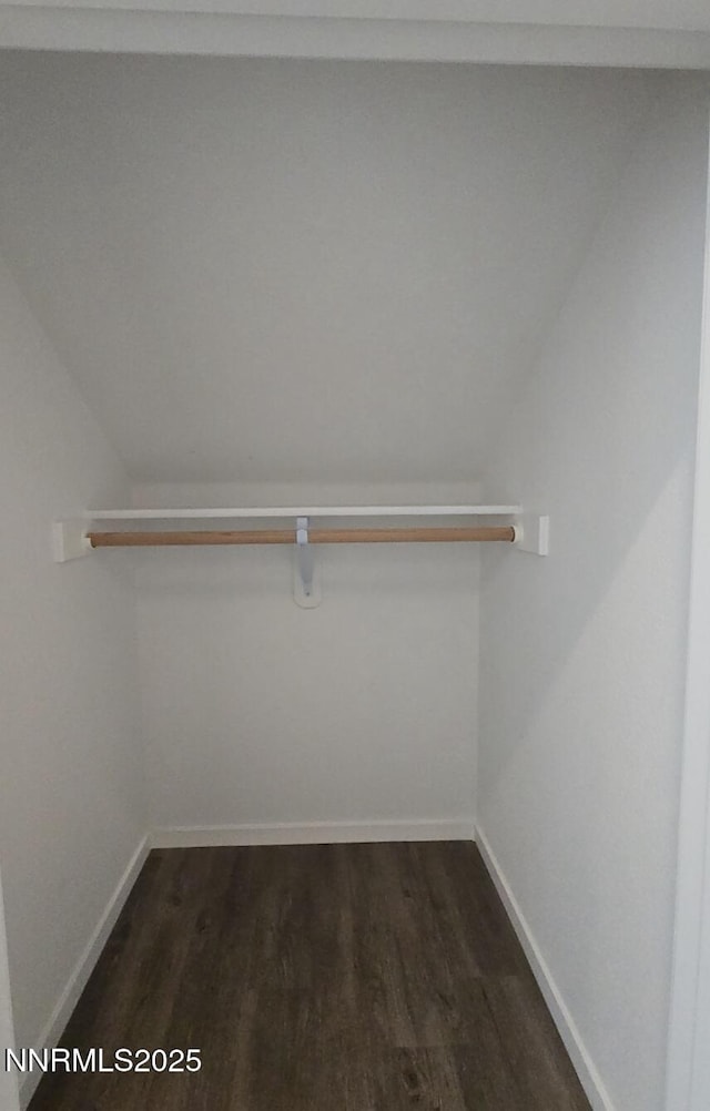 9615 Nautical Mile Rd, Reno, NV 89506 - spacious closet featuring dark wood-style flooring and vaulted ceiling