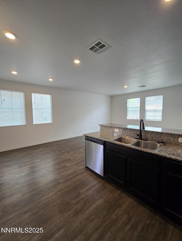 9615 Nautical Mile Rd, Reno, NV 89506 - kitchen with dishwasher, dark wood-style flooring, light stone countertops, dark cabinets, and recessed lighting
