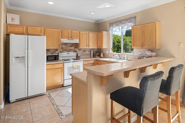 2865 Cintoia Dr, Sparks, NV 89434 - kitchen featuring white appliances, under cabinet range hood, light brown cabinets, a peninsula, and light countertops