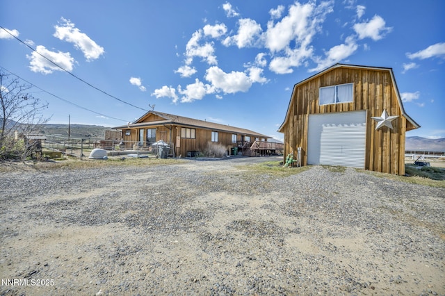 6200 Winnemucca Ranch Rd, Reno, NV 89510 - view of front of property featuring a detached garage, an outdoor structure, board and batten siding, and driveway