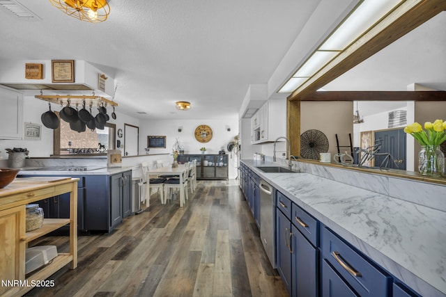 6200 Winnemucca Ranch Rd, Reno, NV 89510 - kitchen featuring blue cabinets, dishwasher, dark wood-type flooring, and a textured ceiling