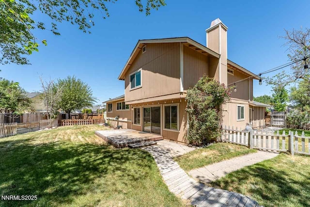1245 Junction Ct, Sparks, NV 89434 - back of property with a chimney, a fenced backyard, and a patio area