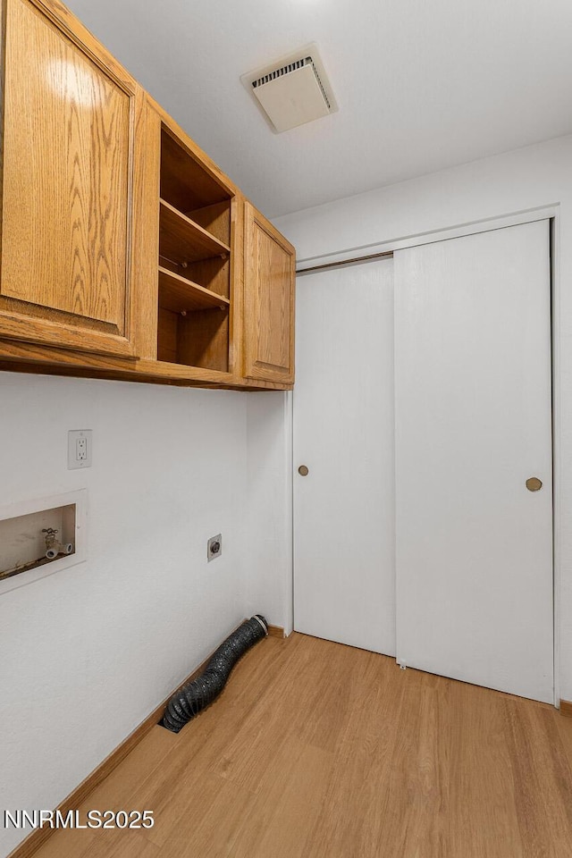 1245 Junction Ct, Sparks, NV 89434 - laundry area featuring cabinet space, light wood-style flooring, washer hookup, and electric dryer hookup