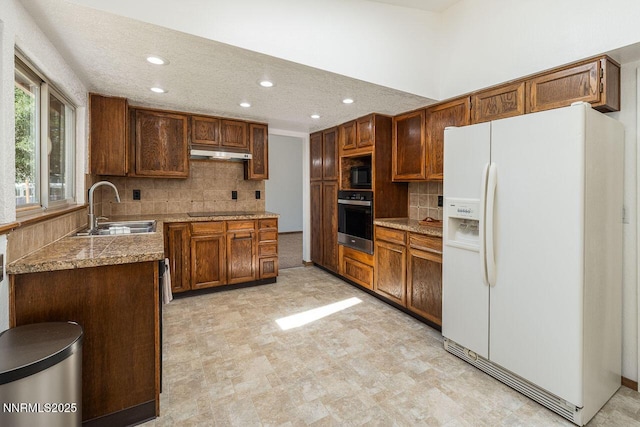 1245 Junction Ct, Sparks, NV 89434 - kitchen featuring black appliances, under cabinet range hood, tile countertops, backsplash, and recessed lighting