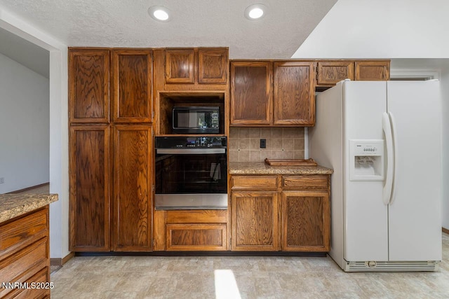 1245 Junction Ct, Sparks, NV 89434 - kitchen featuring white fridge with ice dispenser, stainless steel oven, black microwave, tasteful backsplash, and light stone counters
