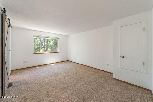 1245 Junction Ct, Sparks, NV 89434 - unfurnished room featuring carpet floors and a barn door