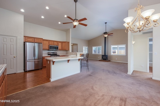 1421 Chiltern Ct, Gardnerville, NV 89410 - kitchen with stainless steel appliances, light carpet, a ceiling fan, light countertops, and a kitchen bar
