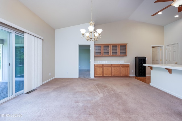 1421 Chiltern Ct, Gardnerville, NV 89410 - unfurnished living room with light carpet, ceiling fan, a chandelier, and high vaulted ceiling