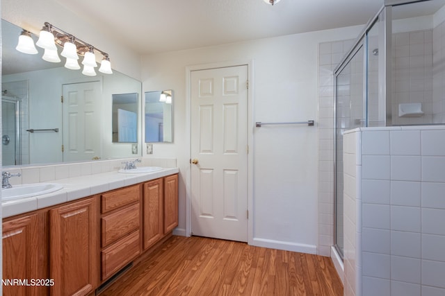 1421 Chiltern Ct, Gardnerville, NV 89410 - bathroom with a shower stall, wood finished floors, and double vanity