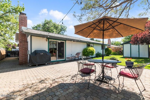 4385 Valdez Way, Reno, NV 89502 - fenced backyard with a grill, a patio, a shed, and outdoor dining area